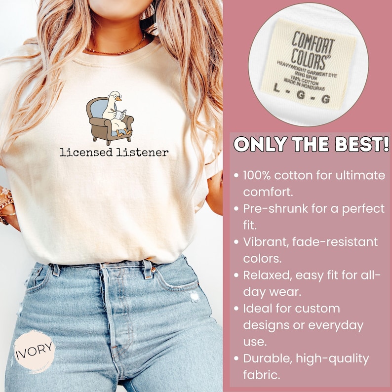 May include: Ivory-colored t-shirt with the text "licensed listener" and a cartoon goose in an armchair reading a book. The shirt is made of 100% cotton and has a relaxed fit. The tag reads "Comfort Colors".