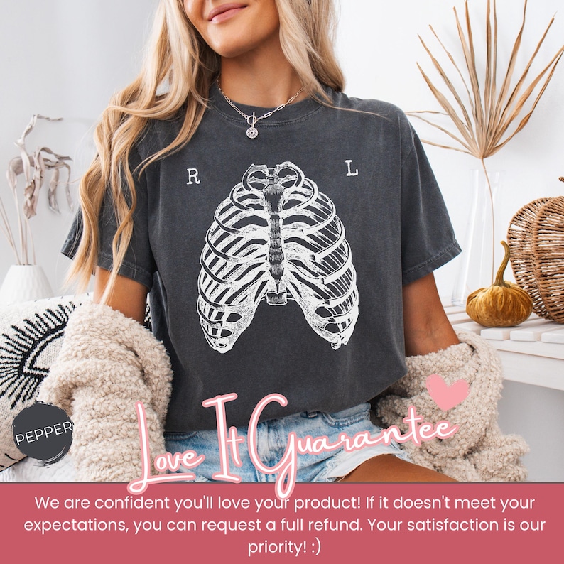 May include: Dark gray t-shirt featuring a white rib cage graphic. The letters "R" and "L" are above the rib cage. The text "Love It Guarantee" is below the graphic.