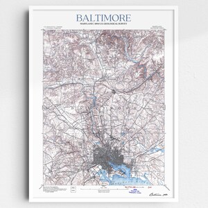 May include: A vintage map of Baltimore, Maryland, printed in black and white with blue and red accents. The map shows the city's streets, waterways, and surrounding areas. The title "Baltimore, Maryland" is printed at the top of the map, and the text "1954 U.S. Geological Survey" is printed below the title.