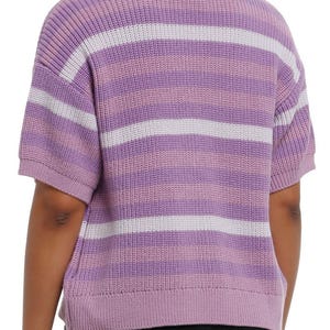 May include: A short-sleeved sweater in shades of purple and white. The sweater features horizontal stripes in varying widths. The ribbed knit fabric has a soft texture. The garment is a casual top.
