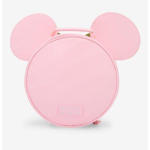 May include: A light pink, round handbag with two large, rounded ears on top, resembling a mouse. The bag has a handle and the text "MINNIE MOUSE" is visible on the front.