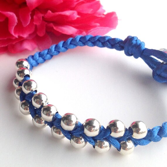 Items similar to BLUE braided silk cord bracelet with silver beads and