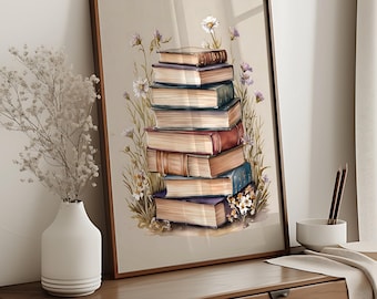 Può includere: Una stampa ad acquerello incorniciata raffigurante una pila di libri d'epoca. I libri, in vari colori, sono circondati da delicati fiori di campo. L'opera d'arte è ambientata su uno sfondo neutro, creando un'estetica classica ed elegante.
