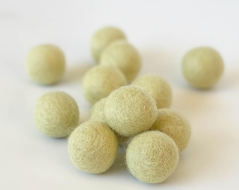 May include: A group of light green felt balls. The balls are soft and fuzzy, and they are perfect for crafts or decorations.