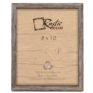 May include: A rustic wood picture frame with a light brown woodgrain finish. The frame is 8x10 inches and has a label that says "Rustic decor" and "100% Recycled Materials Made in the USA Oklahoma City, Oklahoma 73179".