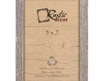May include: A rustic wood picture frame with a light gray finish. The frame is 5x7 inches and has the text "Rustic decor" printed on the front. The back of the frame has the text "100% Recycled Materials Made in the USA Oklahoma City, Oklahoma 73179".