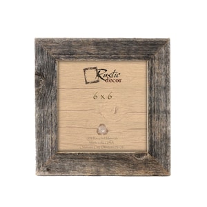May include: A rustic wood picture frame with a 6x6 inch opening. The frame is made from 100% recycled materials and is made in the USA. The frame is gray and has a distressed look.