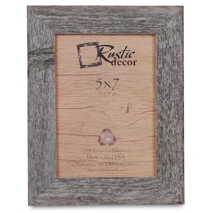 May include: A rustic wood picture frame with a grey finish. The frame is 5x7 inches and is made from 100% recycled materials. The frame is made in the USA and is available from Rustic Decor.