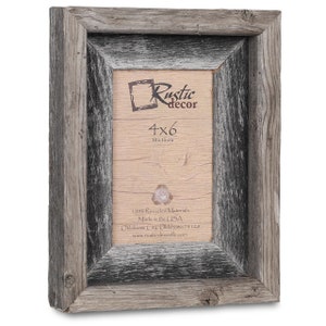 May include: A rustic wood picture frame with a black wash finish. The frame is 4x6 inches (10x15 cm) and is made from 100% recycled materials. The frame is made in the USA.
