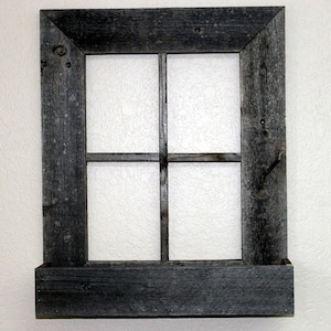 May include: A rustic wooden window frame with a paneled glass insert and a shelf underneath. The frame is painted a dark gray color and has a distressed finish.