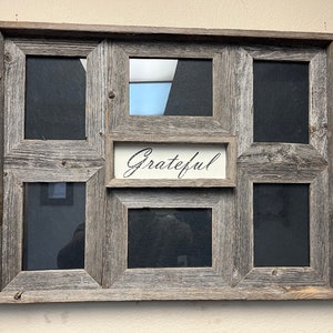 May include: A rustic wood picture frame with six openings for photos. The frame has a distressed grey finish and the word "Grateful" is written on a small plaque in the centre.
