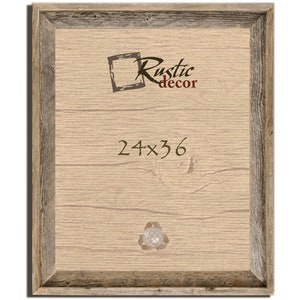 May include: A rustic wood picture frame with a light brown wood finish and a dark brown wood border. The frame is 24 inches by 36 inches. The text "Rustic decor" is printed in the top centre of the frame. The text "24x36" is printed in the centre of the frame.