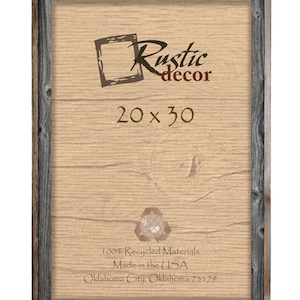 May include: A rustic wood picture frame with a gray wash finish. The frame is 20 inches by 30 inches and is made from 100% recycled materials. The frame is made in the USA and is labeled with the company name "Rustic Decor" and the location "Oklahoma City, Oklahoma 73179".