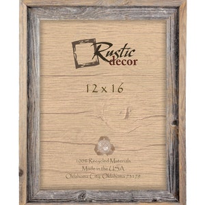 May include: A rustic wood picture frame with a light brown finish. The frame is 12 inches by 16 inches and is made from 100% recycled materials. The frame is made in the USA and is labeled "Rustic decor".