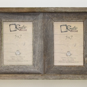 May include: A rustic double picture frame made of reclaimed wood. The frame is gray and brown with a distressed finish. Each frame is 5x7 inches. The frames are joined together with a small piece of wood in the center.