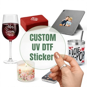 May include: An assortment of personalised items: a wine glass with floral design and text, a red box, a tablet with a photo sticker, a candle, a phone, and a cup with "I Love K-Pop" text. The image also features the text "CUSTOM UV DTF Sticker".