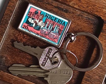 Vaccine Production Keyring - upcycled 1973 used postage stamp from Nigeria