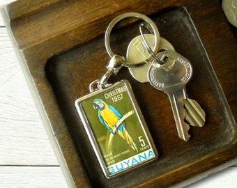 Macaw Keyring, green - upcycled 1967 postage stamp from Guyana