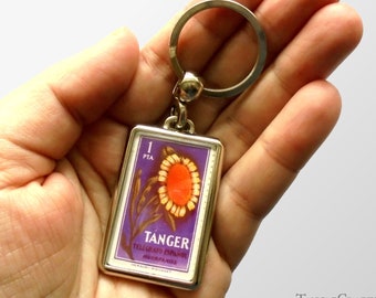Sunflower Keyring, purple background - upcycled 1957 Tangier charity stamp