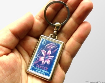 Pink Lily Keyring, blue background - upcycled 1956 Tangier charity stamp