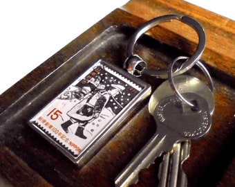 Postman in the snow keyring, made with real vintage 1971 Japan postage stamp