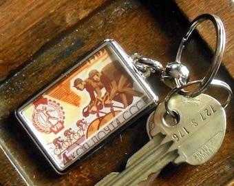 Cycle Race Keyring - upcycled 1965 vintage postage stamp
