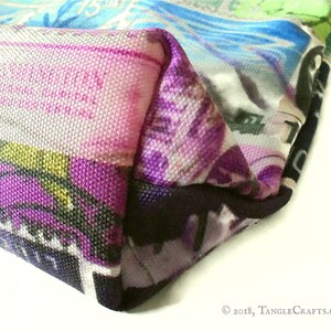 May include: Close-up of a colourful tote bag with a purple, black and white design. The bag is made of canvas and has a  "TangleCrafts.co.uk" label.