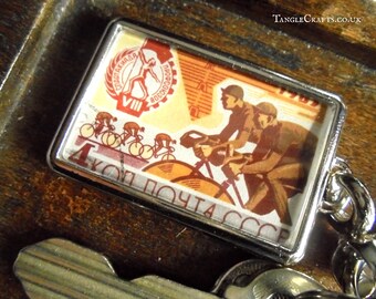 Cycle Race Keyring - upcycled 1965 vintage postage stamp