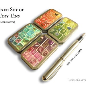 May include: Set of four small, empty, metal tins with vintage postage stamp designs. Each tin has a different colour scheme, including red, green, blue, and pink. The tins are arranged in a square shape on a white background. The text "MIXED SET OF 4 TINY TINS (SUPPLIED EMPTY)" is visible at the top of the image. A silver pen is lying on the right side of the image. The text "PEN NOT INCLUDED" is visible below the pen.