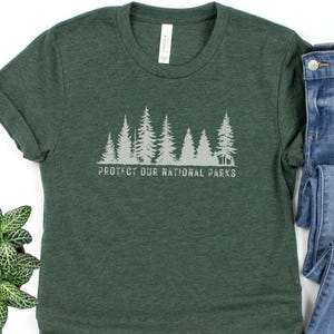 May include: A green t-shirt with a white graphic of trees and the text "Protect Our National Parks".