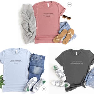 May include: Three t-shirts in different colors: mauve, light blue, and asphalt. Each t-shirt has the same text printed on the front: 'I paid for a vacation while relaxing on the floor. Stay Home.' The t-shirts are displayed on a white background with jeans, sandals, and a sweater.