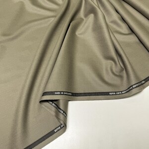 Discover a high-quality Merino Wool in sage color (olive) with a touch of Cashmere thread. This Fabric is ideal for suits, trousers. Merino Wool is a luxurious fabric, made with cashmere fibers, extremely soft and comfortable to wear. This fabric lends a sophisticated look and style to the items made from it.