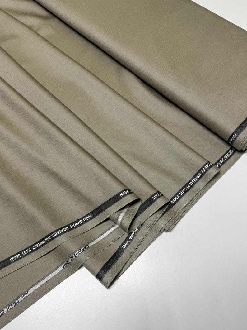 Discover a high-quality Merino Wool in sage color (olive) with a touch of Cashmere thread. This Fabric is ideal for suits, trousers. Merino Wool is a luxurious fabric, made with cashmere fibers, extremely soft and comfortable to wear. This fabric lends a sophisticated look and style to the items made from it.