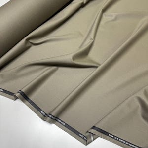 Discover a high-quality Merino Wool in sage color (olive) with a touch of Cashmere thread. This Fabric is ideal for suits, trousers. Merino Wool is a luxurious fabric, made with cashmere fibers, extremely soft and comfortable to wear. This fabric lends a sophisticated look and style to the items made from it.