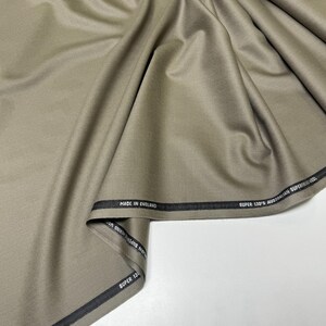 Discover a high-quality Merino Wool in sage color (olive) with a touch of Cashmere thread. This Fabric is ideal for suits, trousers. Merino Wool is a luxurious fabric, made with cashmere fibers, extremely soft and comfortable to wear. This fabric lends a sophisticated look and style to the items made from it.