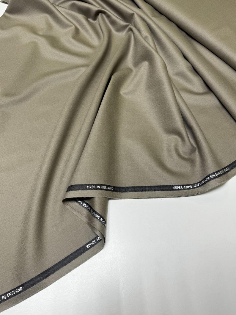 Discover a high-quality Merino Wool in sage color (olive) with a touch of Cashmere thread. This Fabric is ideal for suits, trousers. Merino Wool is a luxurious fabric, made with cashmere fibers, extremely soft and comfortable to wear. This fabric lends a sophisticated look and style to the items made from it.