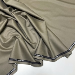 Discover a high-quality Merino Wool in sage color (olive) with a touch of Cashmere thread. This Fabric is ideal for suits, trousers. Merino Wool is a luxurious fabric, made with cashmere fibers, extremely soft and comfortable to wear. This fabric lends a sophisticated look and style to the items made from it.