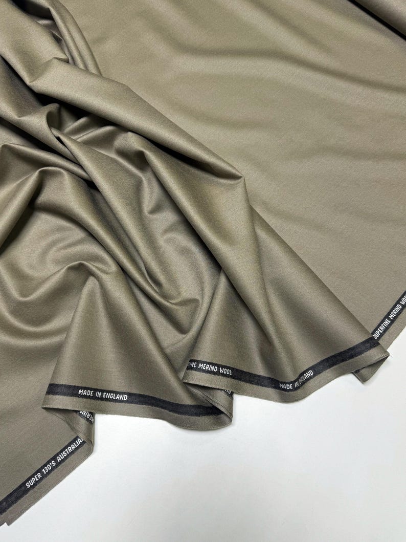 Discover a high-quality Merino Wool in sage color (olive) with a touch of Cashmere thread. This Fabric is ideal for suits, trousers. Merino Wool is a luxurious fabric, made with cashmere fibers, extremely soft and comfortable to wear. This fabric lends a sophisticated look and style to the items made from it.
