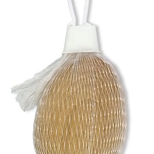 May include: A brown, round object wrapped in a white mesh bag with a white plastic handle.