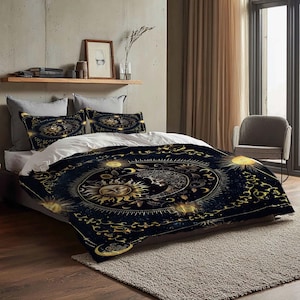 May include: A bed with a dark blue comforter and matching pillowcases featuring a celestial design with suns, moons, and stars in gold. The bedding is on a bed with white sheets, a wooden headboard, and a neutral-colored rug.