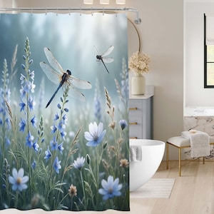 May include: A shower curtain featuring a serene meadow scene with blue wildflowers and two dragonflies. The dragonflies have translucent wings and are set against a soft, blurred background. The curtain adds a touch of nature to any bathroom.