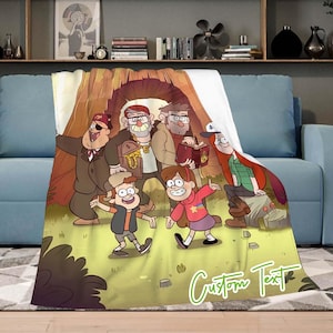 May include: A soft blanket with a cartoon illustration of characters from the animated series Gravity Falls. The design features the characters in a forest setting with the text "Custom Text" in a green cursive font.