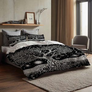 May include: A black and white bedding set featuring a detailed tree of life design. The set includes a duvet cover and two pillowcases, all with the same intricate pattern. The design incorporates celestial elements like stars and suns.