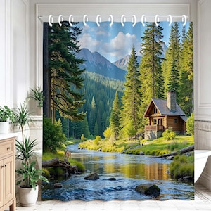 May include: A shower curtain featuring a printed landscape of a log cabin nestled in a dense pine forest beside a flowing river. The scene includes tall evergreen trees, distant mountains under a blue sky, and a small deer standing near the water.