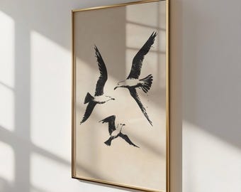 May include: A framed print with a minimalist design featuring three black silhouettes of seagulls flying in formation against a beige background.