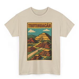 Puede incluir: Camiseta beige con un diseño gráfico de estilo vintage de las pirámides de Teotihuacan. La ilustración incluye el texto "TEOTIHUACÁN" en la parte superior, con pirámides en tonos rojos, amarillos y verdes sobre un cielo azul con nubes. La camiseta es de cuello redondo.
