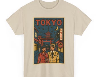 May include: Beige t-shirt featuring a vintage-style graphic of a couple walking in Tokyo at night. The design includes a pagoda, a red torii gate, and the word "TOKYO" in bold letters. The shirt has a classic crew neck.