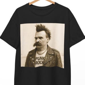 May include: Black t-shirt with a photo of a man with a mohawk and a mustache wearing a leather jacket and a white t-shirt that says "Punk Rock".