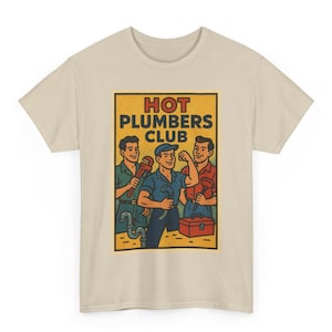 May include: Beige t-shirt featuring a retro-style graphic of three plumbers. The graphic, set against a yellow background, reads "HOT PLUMBERS CLUB" and depicts the plumbers with tools and a toolbox. The shirt is made of a soft, neutral-colored fabric.