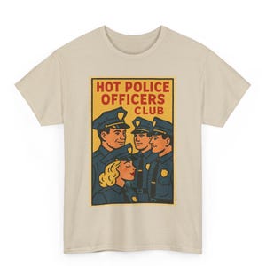 May include: Beige t-shirt featuring a retro-style graphic of four police officers in uniform. The graphic is in a rectangular frame with the text "HOT POLICE OFFICERS CLUB" in red and yellow.